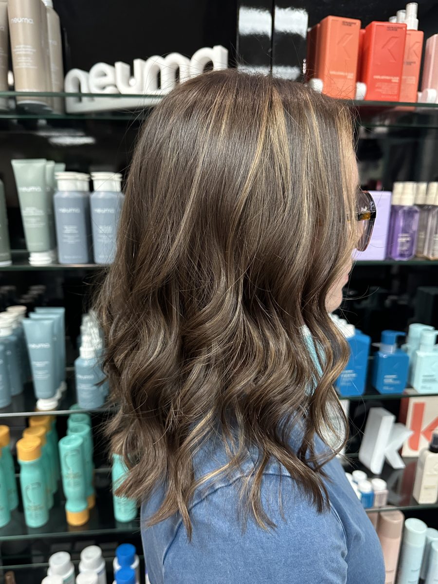 Back view of long hair with dimensional highlights and waves after service at K Bella Hair Studio & Spa in Brighton, MI by Liberty Greenwood
