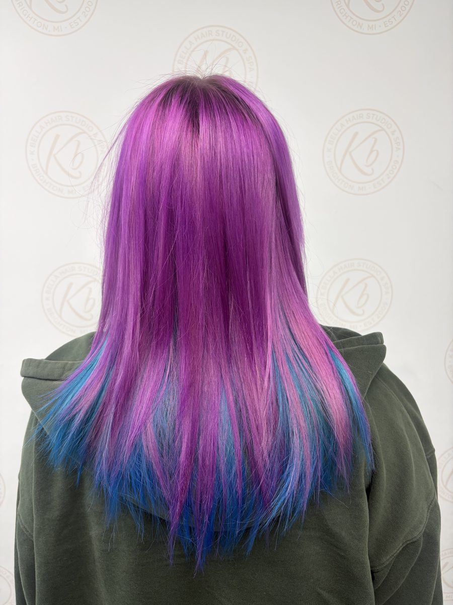 Back view of shoulder-length hair in vivid magenta and electric blue, freshly colored by Abbey French at K Bella Hair Studio & Spa in Brighton, MI.