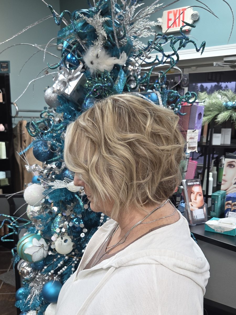 Angled rear view of a chin-length wavy blonde bob with soft layers by Katie Rowe at K Bella Hair Studio & Spa in Brighton, MI