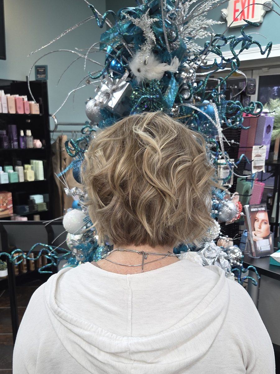 Rear view of a layered blonde bob with rich, dimensional wave texture by Katie Rowe at K Bella Hair Studio & Spa in Brighton, MI