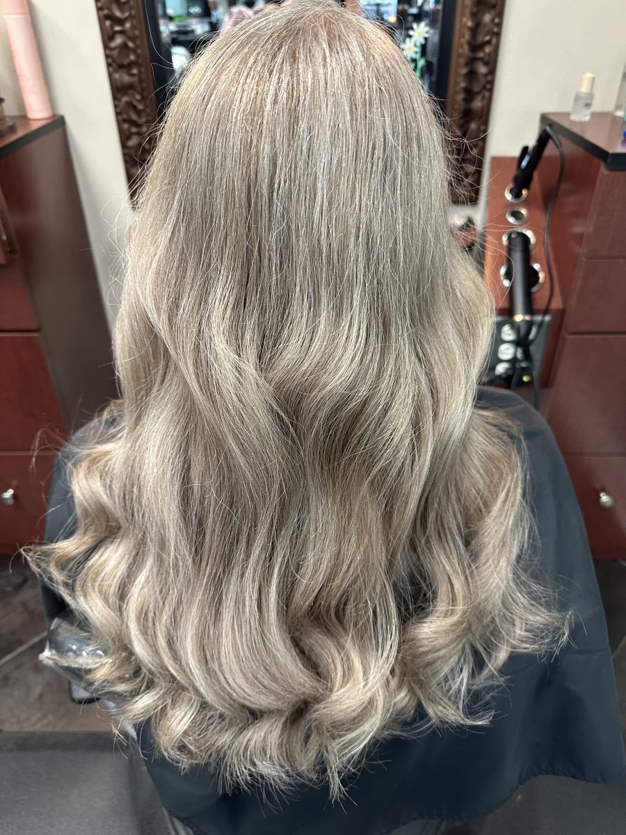 Back view of shoulder-length hair with soft waves and blended gray tones by Allison Bowsher at K Bella Hair Studio & Spa in Brighton, MI