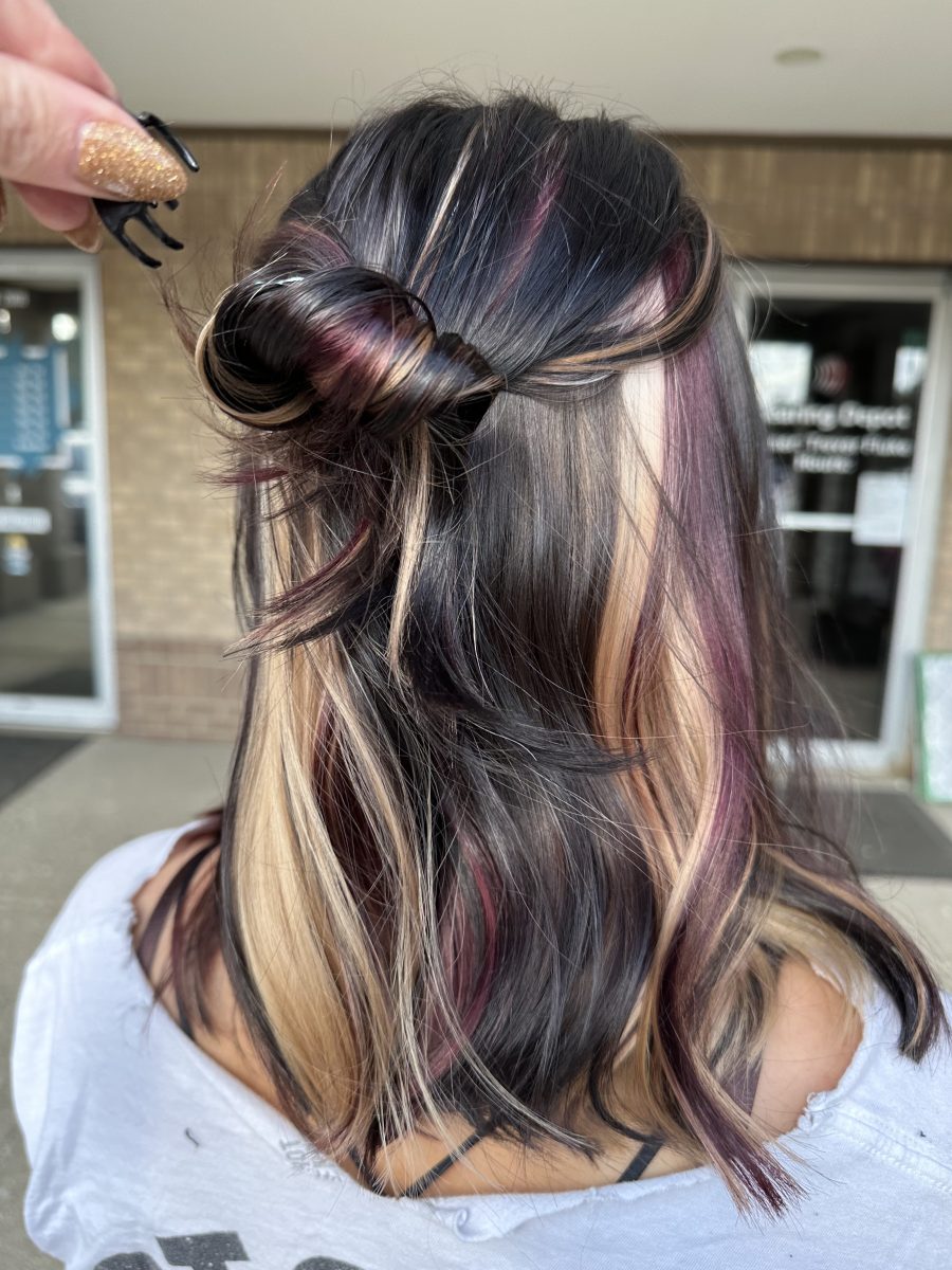 Finished calico hair color with burgundy and caramel tones in waves, back view by Allison Bowsher at K Bella Hair Studio & Spa in Brighton, MI